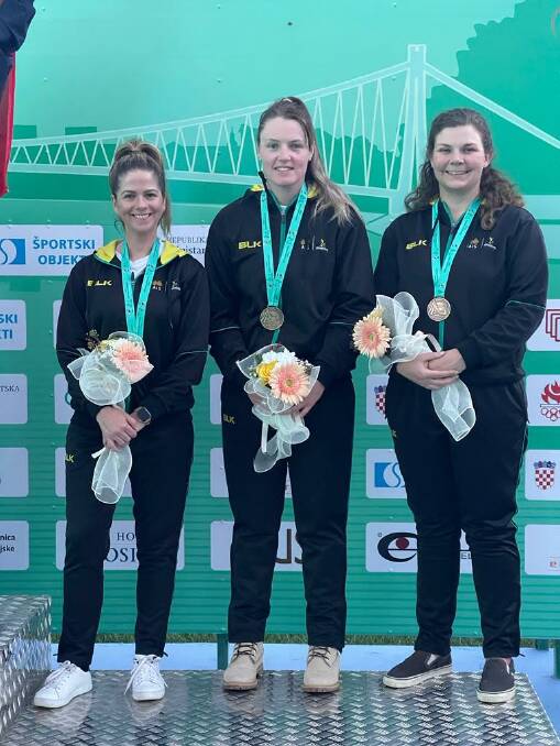 Laetisha Scanlan, Penny Smith and Catherine Skinner celebrate with the bronze medal at the world championships.
