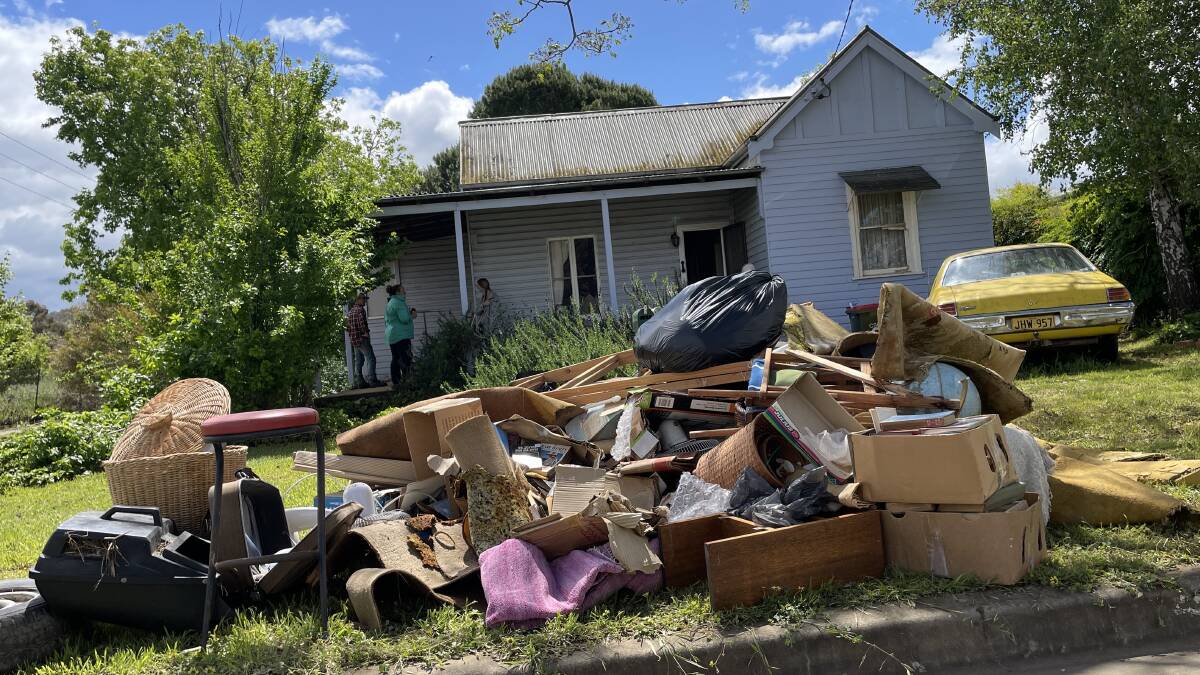 Piles of ruined belongings in front of Jane Herring's home.