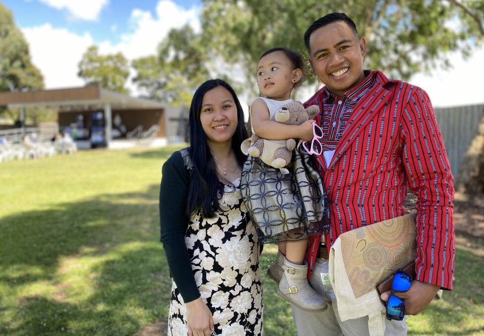Newly-naturalised Australian citizen Marlon Bolauitan, right, with daughter Zariah Bolauitan, middle, and wife Mary Bolauitan, left.