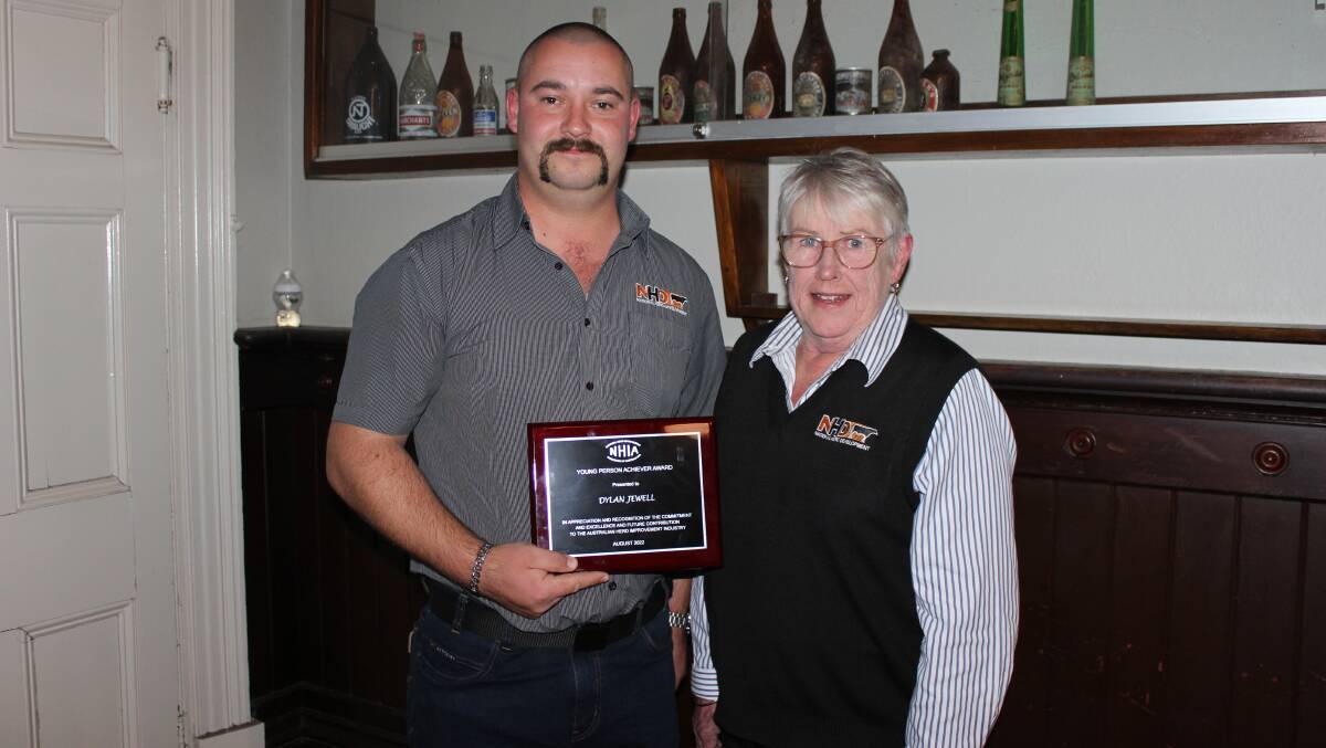 HONOURED: Dylan Jewell, left, accepted his a young achiever award from his supervisor Maree Condon, right, for his work in cattle breeding advisory and sales. Picture: Supplied