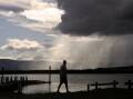 Dramatic rain clouds dominate the sky off Lake Illawarra. Picture by Sylvia Liber. 