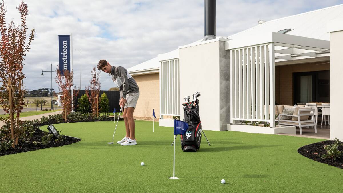 BACKYARD GOLF: Caleb Perry, 22, is a rising golf champion and was "pleasantly surprised at how well this green measured up." Photo: Supplied.