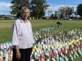 Eileen Button in front of the Sea of Hands created by Macleay Valley students. Picture by Ellie Chamberlain