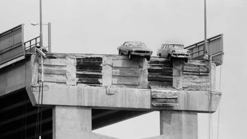 Frank Hanley's Holden Monaro on the left dangling over the missing span following the tragedy that claimed 13 lives in 1975. File picture