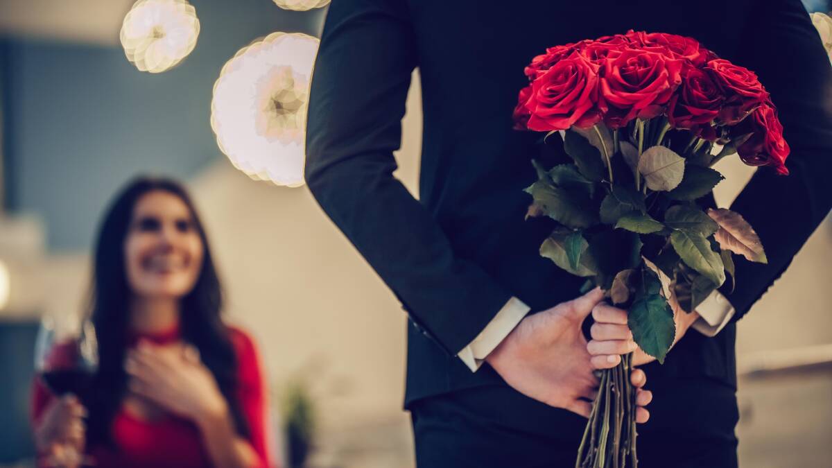 Woman is surprised with red roses. Picture by Shutterstock.