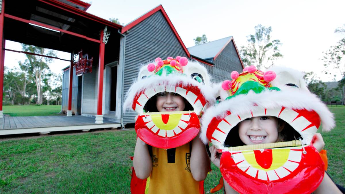 Children celebrate the Lunar New Year outside the corrugated iron temple in Atherton. Picture supplied