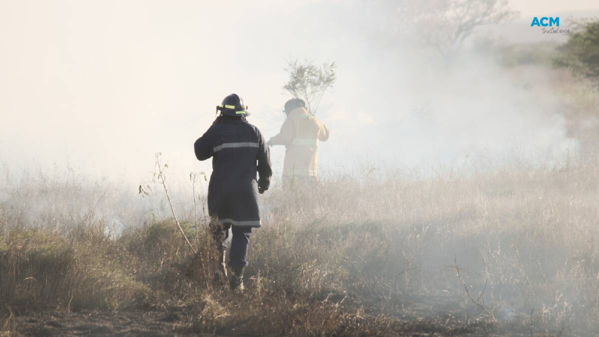 Firefighters walk into thick smoke. File picture