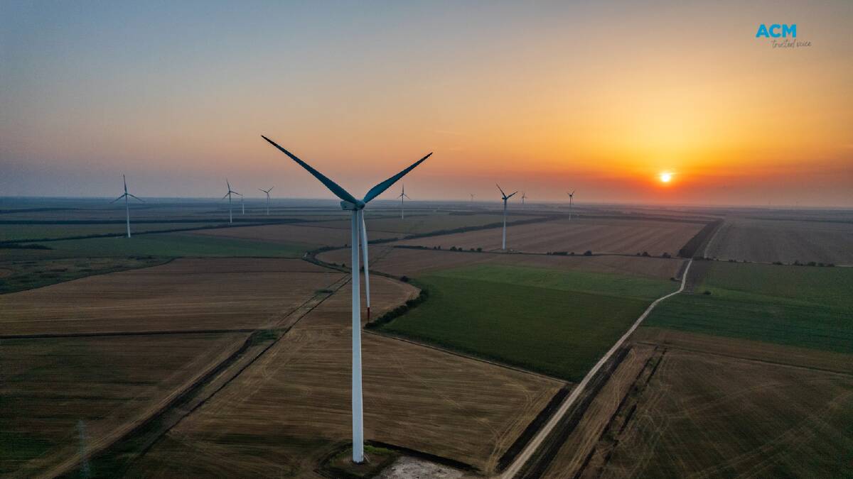 Wind turbines with a setting sun in the background. Picture by Stefan Mitev via Canva