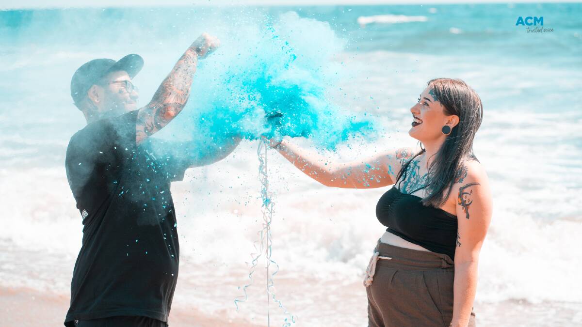 A couple find out their child will be born male by popping a balloon filled with blue sparkles and pigment. Picture via Canva