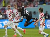 Canada's Atiba Hutchinson, center, vies for the ball with Croatia's Marcelo Brozovic, left, and Luka Modric during the World Cup group F soccer match between Croatia and Canada, at the Khalifa International Stadium in Doha, Qatar, Sunday, Nov. 27, 2022. Picture by AP Photo/Martin Meissner
