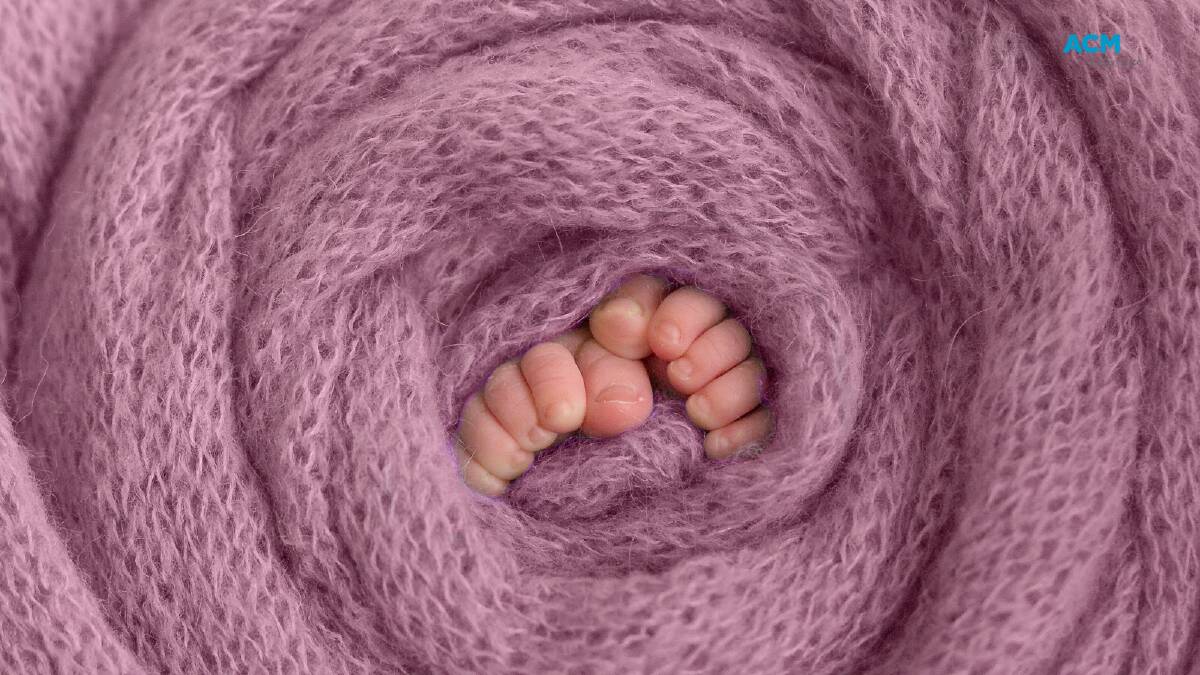 Tiny toes poke out from a thick swaddling blanket. File picture.