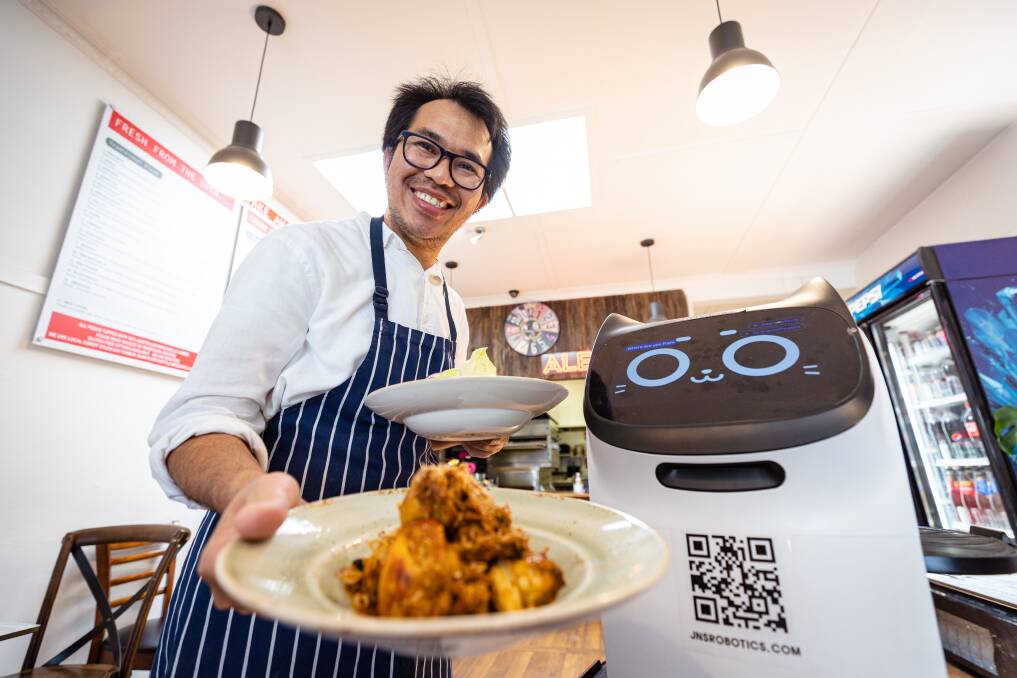Alex Hutabarat has decided to keep AI-run waiter BellaBot at Alexo Pizza and Bistro after a three-month trial. Picture by Sean McKenna