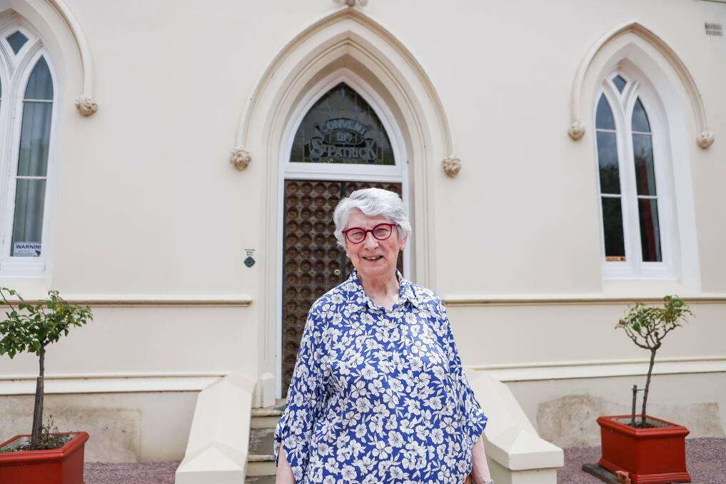 Sister Jill O'Brien standing in front of the doors she walked out of 50 years ago. Pictures by Anthony Brady