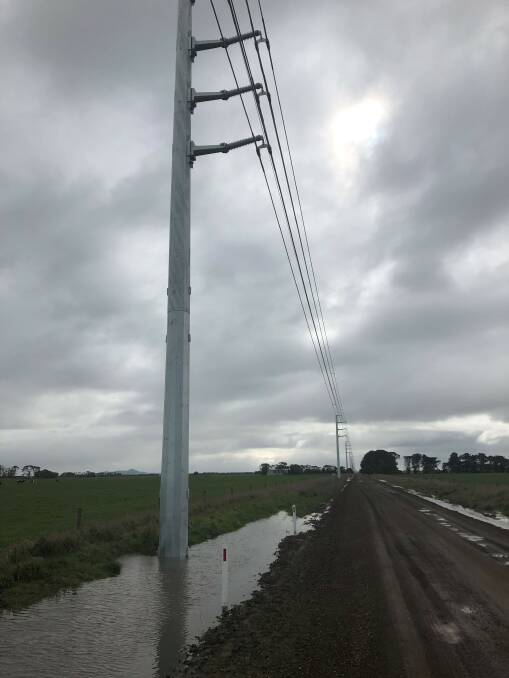 Part of the transmission line from the Salt Creek wind farm runs along a road culvert at Kolora, south of Mortlake.