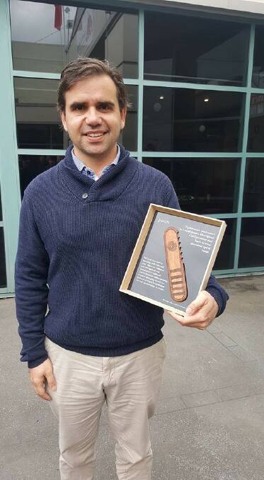 New CEO: New Gunditjmara Aboriginal Cooperative chief executive Jason Kanoa with a message stick he received from the Gunditjmara community during his welcome and smoking ceremony in Warrnambool.