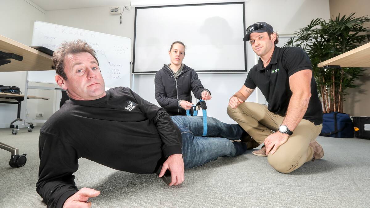 Advanced care: Port Fairy abalone diver and WADA chairman Craig Fox receives treatment from Lara deckhand Tara Hicks and first aid trainer Jake Hickey. Picture: MIchael Chambers