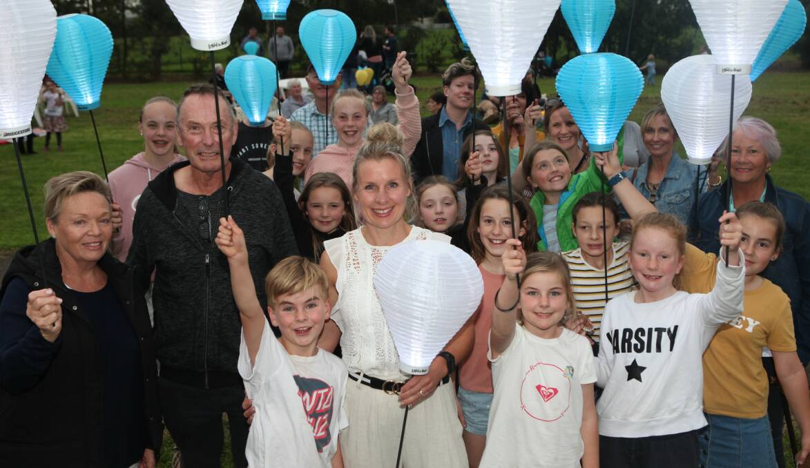 Light the Night: Adele MacDonald, centre, with her three children and other Koroit community members at the Light the Night event. Picture: Everard Himmelreich