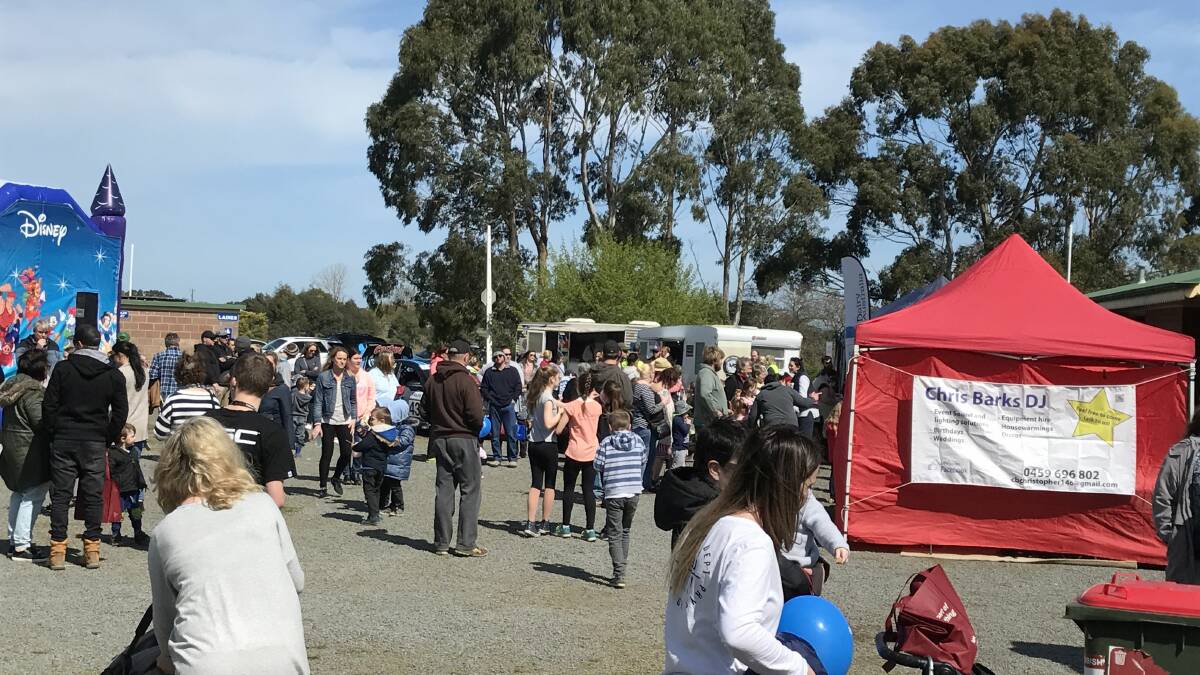 Enjoying a break: Part of the big crowd of 1500 people who attended the South West Dairy Community "Free Family Fun Day" in Cobden on Sunday. 