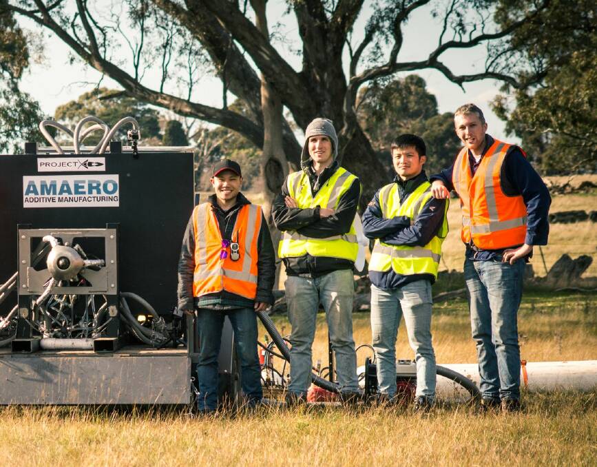 Revolutionary: Marten Jung, right, formerly of Warrnambool, and other team members with the innovative "aerospike" rocket engine they made using 3D printing.