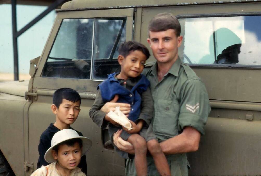 Back then: Ken Cumming of Warrnambool holds "Rabbit," a Vietnamese boy he got to know during his time as a national serviceman in the Vietnam War. 