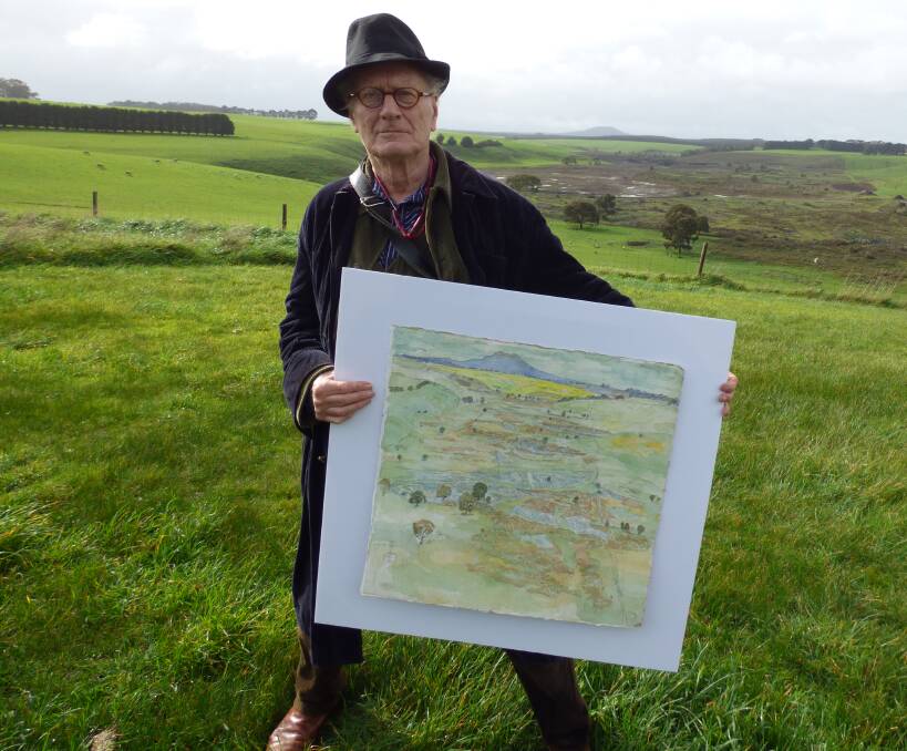 Disgusted: Acclaimed landscape artist John Wolseley, holding his painting of the Harman's Valley lava flow, stands in front of the area where the lava flow once was. Picture: Terry Sim 