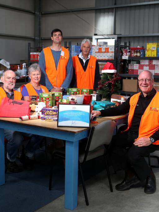Helping out: Food Share's Dedy Friebe (right) with volunteers Peter Auld, Jeanette Brennan, Steve Paul and Cliff Heath and donated Christmas items. Picture: Amy Paton
