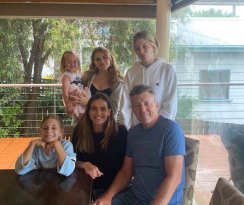 FAMILY AFFAIR: Adam Hamilton, wife Kirby with children Emily (sitting), Luna being held by Jess and Ali, enjoying Port Fairy.
