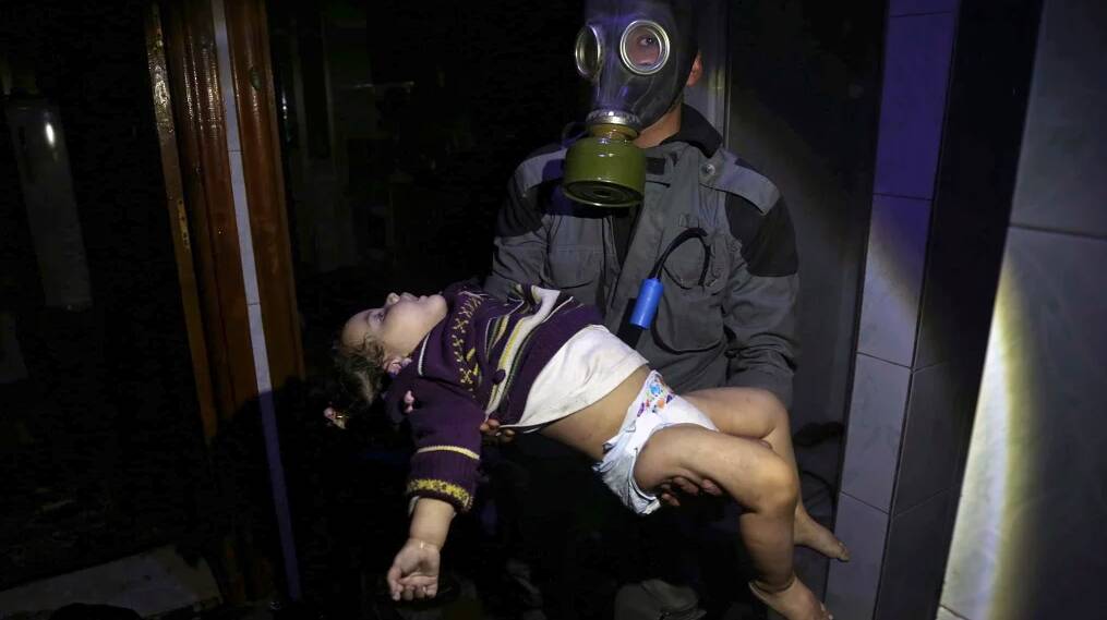 A rescue worker carries a child following an alleged chemical weapons attack in the rebel-held town of Douma, near Damascus, on Saturday night.
Photo: Syrian Civil Defence White Helmets via AP