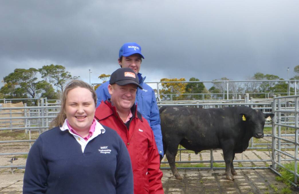 Sale top: Holly McLeod and her father Steven McLeod, of Macarthur, with (at rear) Banquet Angus's Hamish Branson and the top-priced bull.