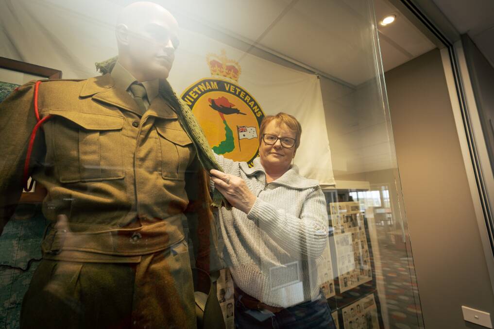 RSL Warrnambool's volunteer co-ordinator Tonia McMahon with some of the Vietnam War memorabilia. Picture by Sean McKenna