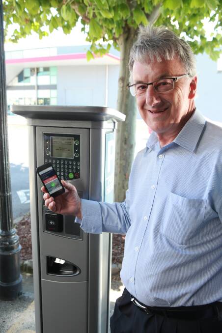 MOVING WITH THE TIMES: Warrnambool City Council mayor Rob Anderson stands beside one of the new parking meters in the city centre. 