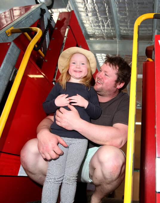 ALL SMILES: Robert Gregg and daughter Emily, 3, explore a fire truck at the Warrnambool Fire Station open day. Pictures: Amy Paton