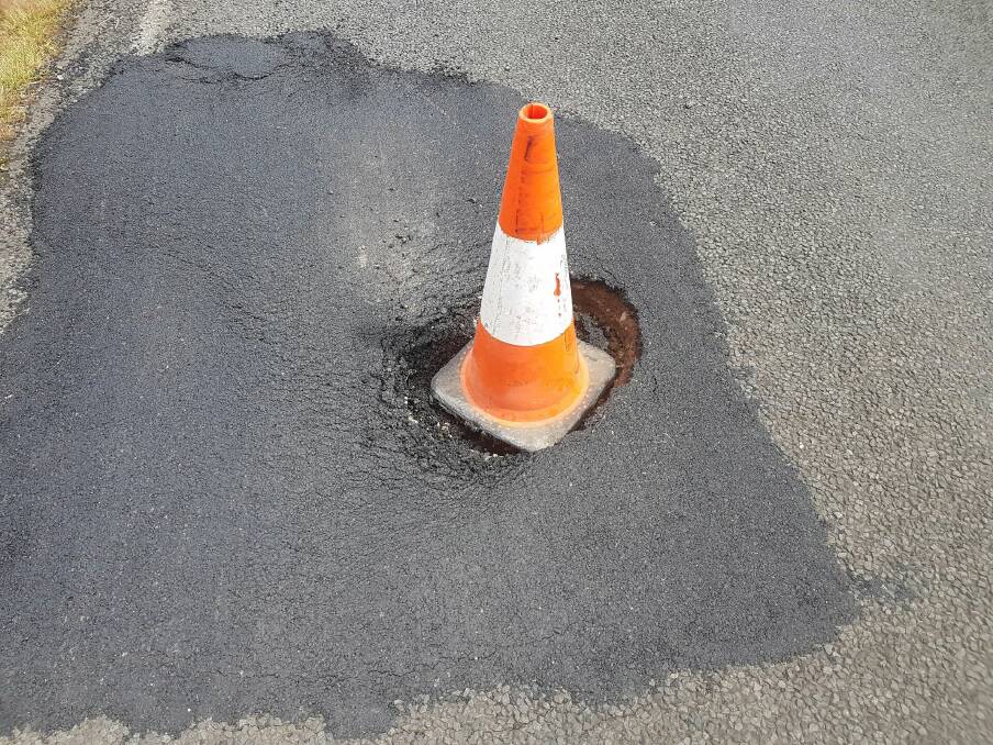 Halloween is coming, but this witch’s hat marks a deep pothole