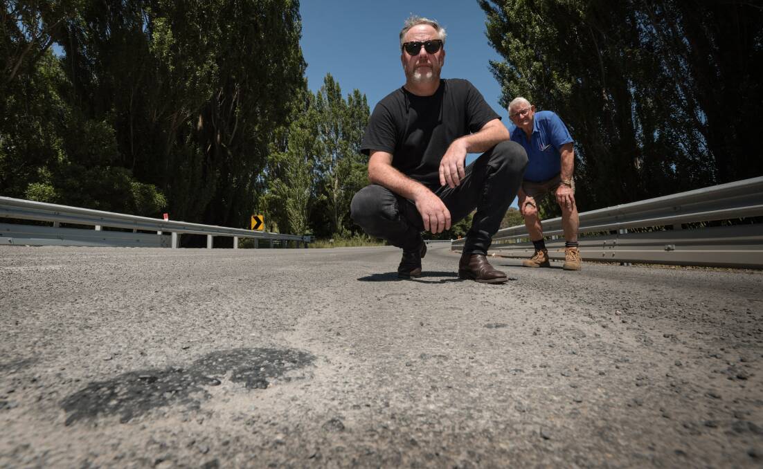 Timboon Fine Ice Cream owner Tim Marwood and Peter Pope are furious a section of the newly-re-surfaced Timboon-Nullawarre Road had been damaged. Picture by Sean McKenna