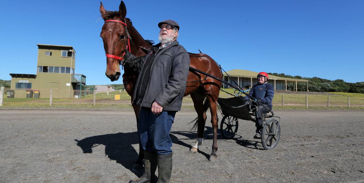 STILL TICKING ALONG: Warrnambool Harness Racing Club secretary Peter Matthews with driver Neil Kelly and Okelerho Lad, trained by Geoff Senior. Picture: Rob Gunstone 