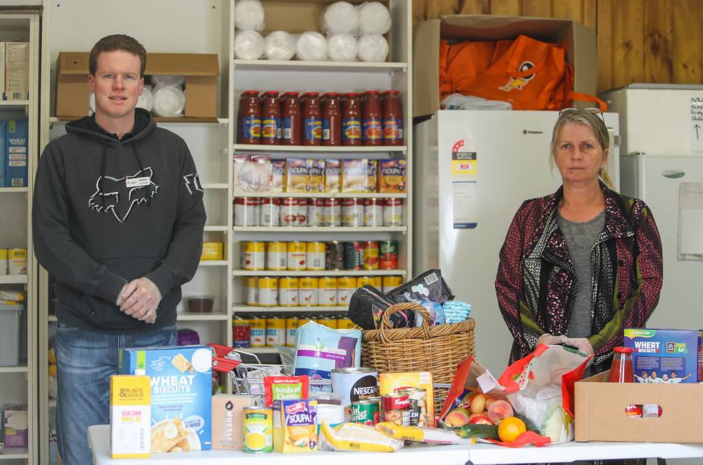 HELPING THOSE WHO NEED IT MOST: Aaron Hume and Louise Serra pictured with food supplies at Anglicare. Picture: Morgan Hancock