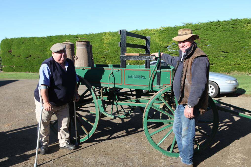LONG TIME SUPPORTERS: Illowa's Norm McCosker (right) with brother Billy stand in front of a wagonette, identical to the cart the pair's parents used to transport milk in cans to the Dennington factory. Picture: Rachael Houlihan