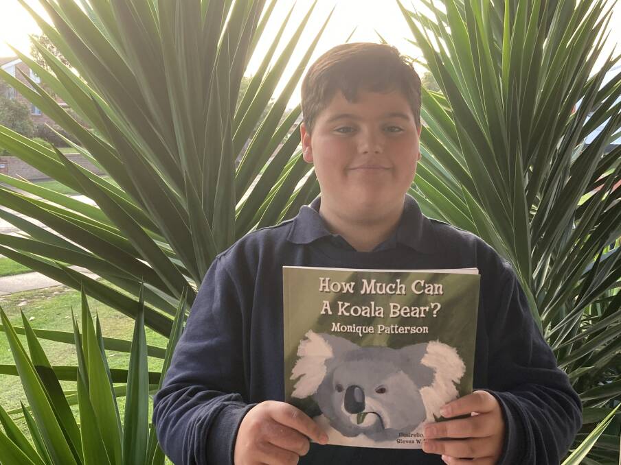 HELPING HAND: The Standard journalist and author Monique Patterson's son Cael Campbell, 11, with a copy of the book. Funds from the sale of the book will go to the family of Cooper Onyett. 