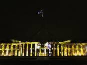 The famous "wattle painting" was one of many images reflecting the Queen's long and deep relationship with Australia to be projected upon Parliament House. Picture: Keegan Carroll