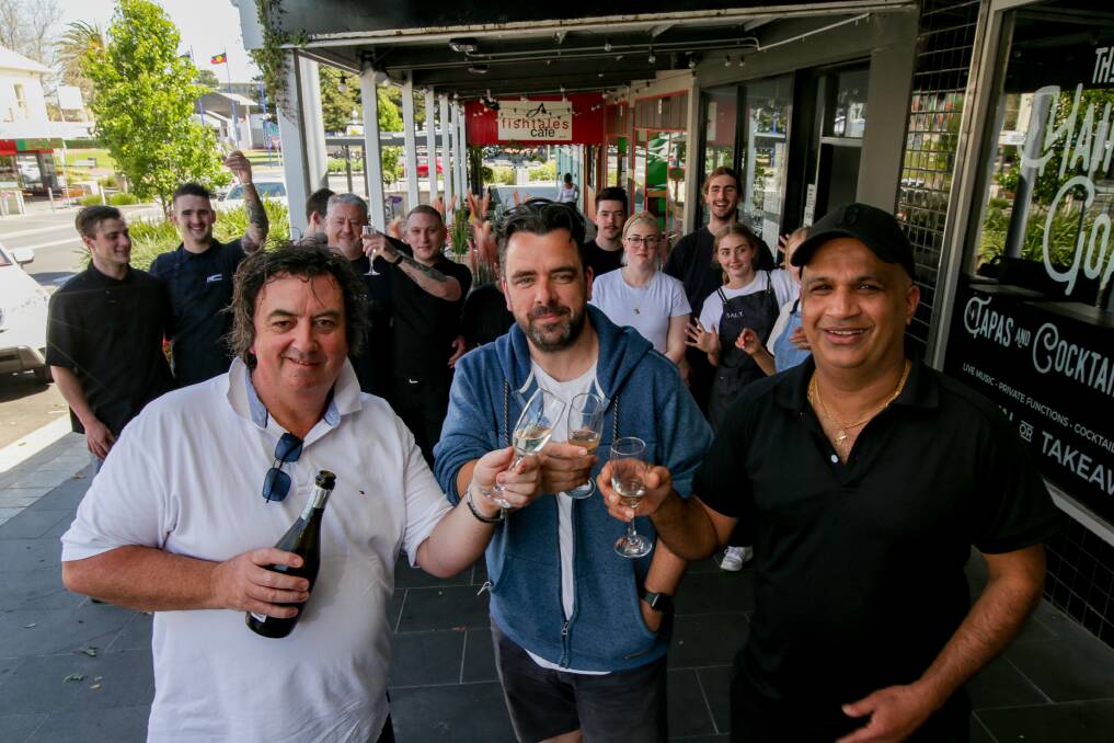 CHEERS: Bojangles owner Simon Mugavin, The Hairy Goat owner Jade Kelson and Bundy's Bar and Bites owner Jayaweera 'Bundy' Bandara celebrate the lift on patron limits with staff members. Picture: Chris Doheny