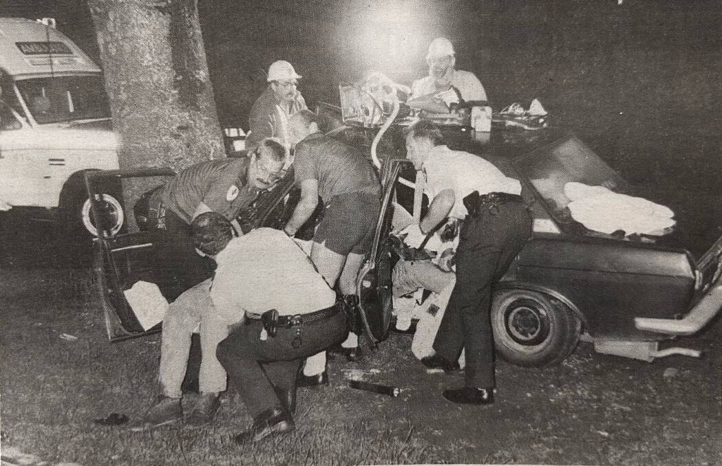 Emergency services work to remove injured occupants, including Glenn Heazlewood, from a car on Pertobe Road in November 1993. Picture by Sean McKenna
