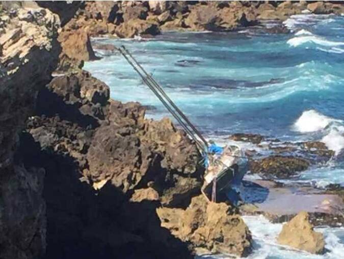 DELICATE OPERATION: The Patricia Mary washed up on rocks at Lake Gillear. Picture: Supplied