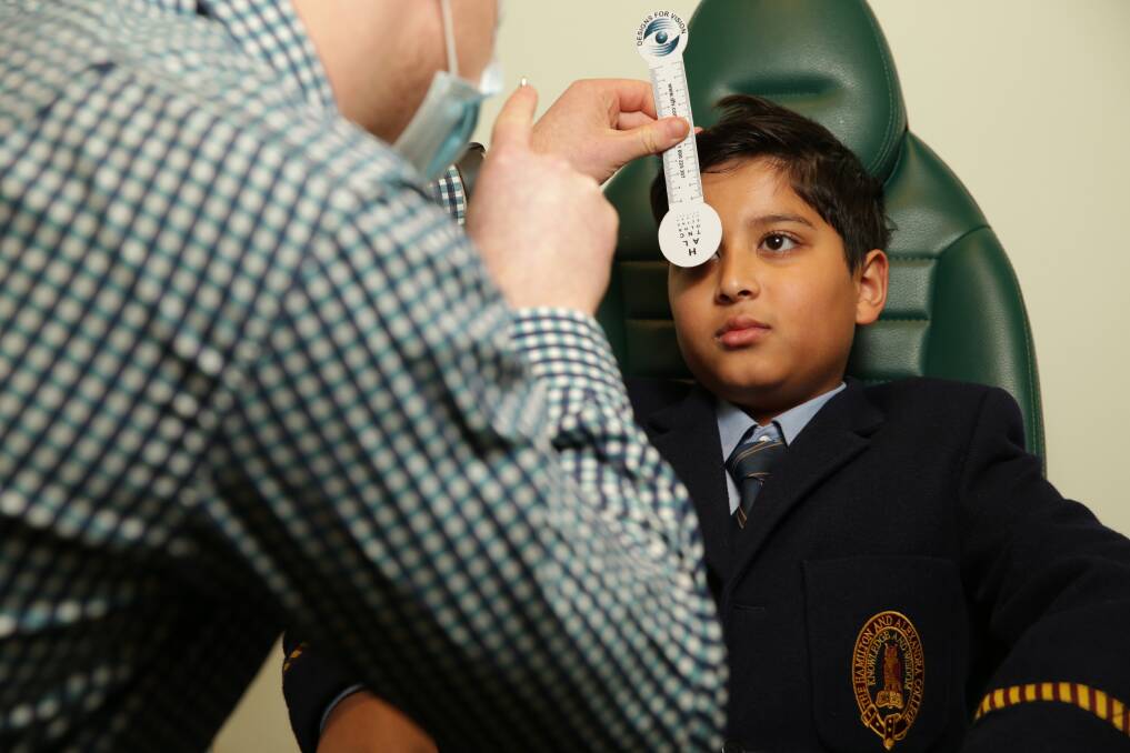 TIME TO GET TESTED: Specsavers Warrnambool optometrist Cameron Skinner conducts an eye exam on Reian Patel. Picture: Chris Doheny