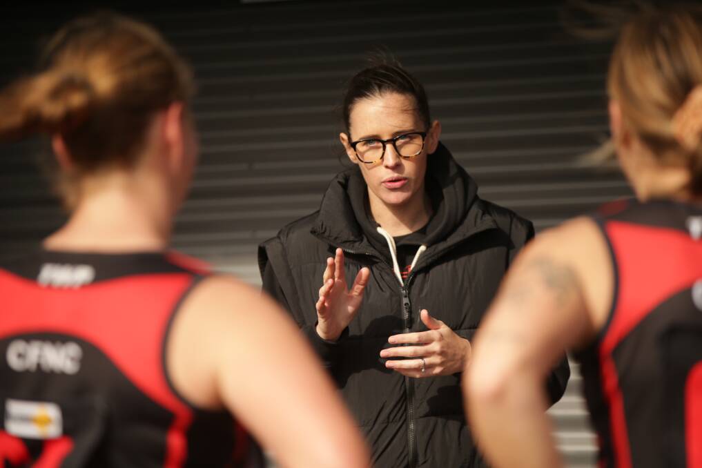 GAME-PLAN: Cobden coach Sophie Hinkley talks to her players at quarter-time in the Bombers' match against Koroit.