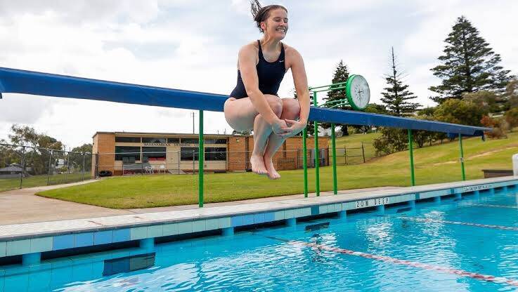 MAKE A SPLASH: Swimmer Lily Weise jumps into AquaZone's outdoor pool, which will reopen on September 28. Picture: Morgan Hancock