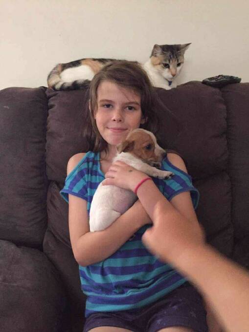 Josie Pinheiro in her younger years snuggling up to some furry friends.