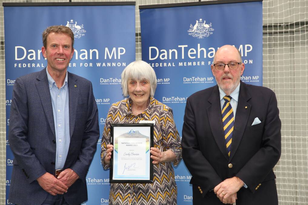 Cindy Benson, centre, is presented her award by Dan Tehan and Mick Murphy.