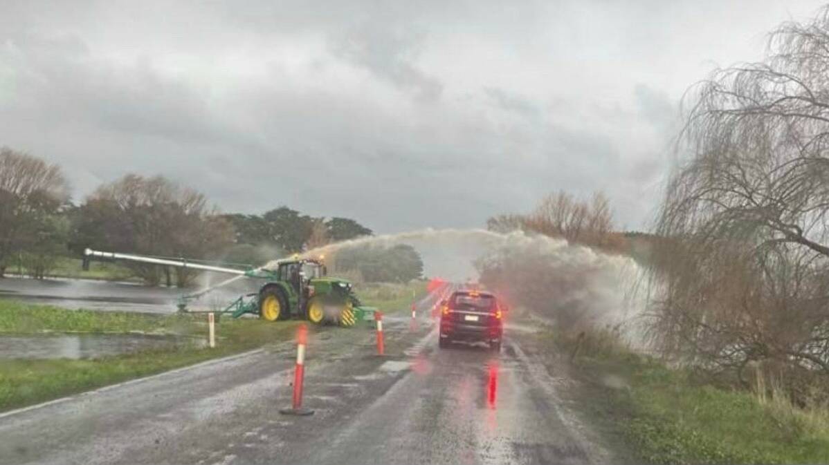 An attempt is made to clear water off the road. Picture supplied