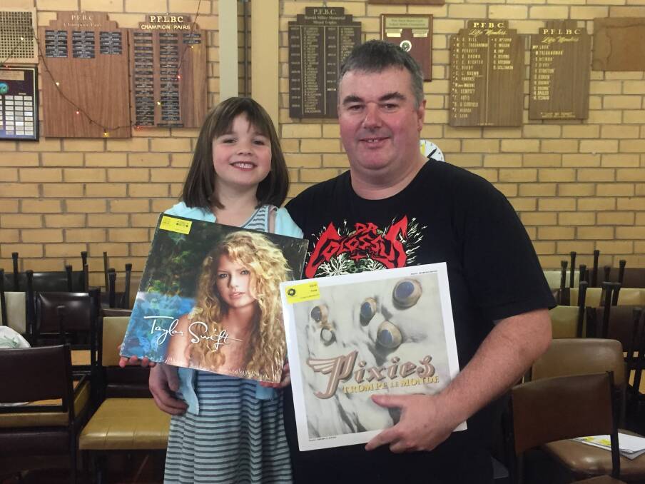 HELPING DAD: Catherine Godfrey helps her dad Shane, who owns Prehistoric Sounds in Warrnambool, at the vinyl swap meet. Pictures: Monique Patterson