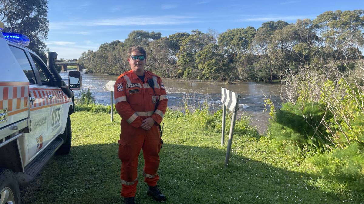 Warrnambool SES volunteer Christian Mazzocato assesses the water level of the Hopkins River at Allansford. Picture by Monique Patterson